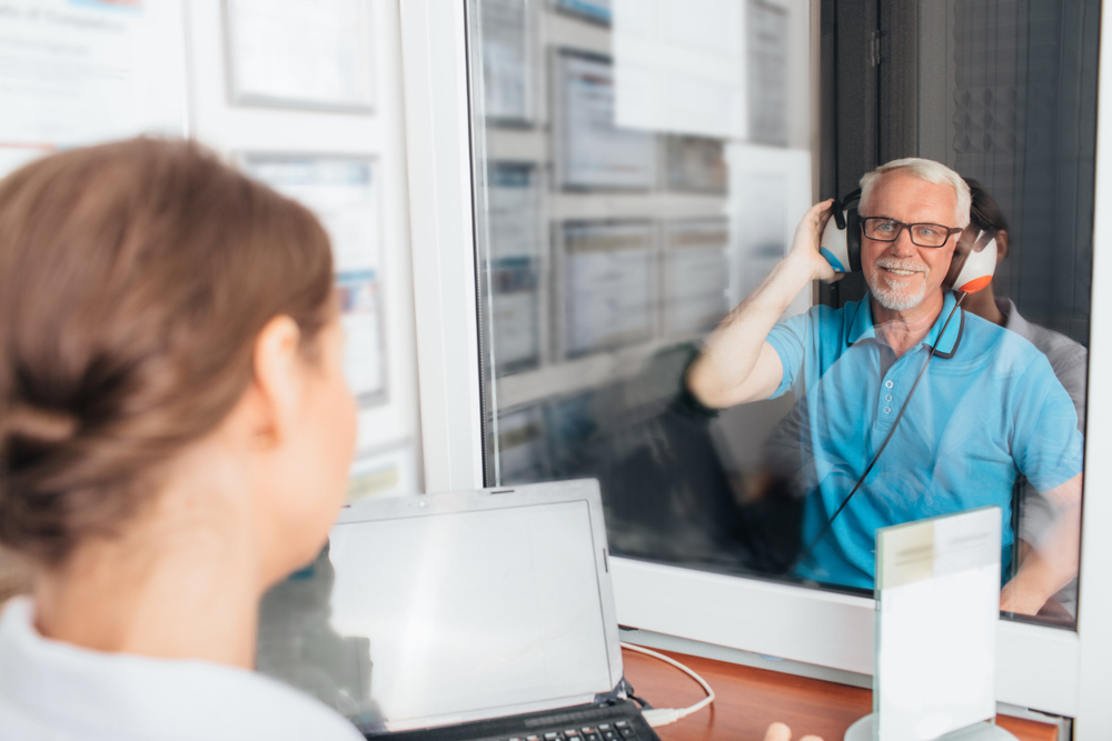 A standard hearing test involves listening for tones in both ears. You raise your hand on the side where you hear the tone. 