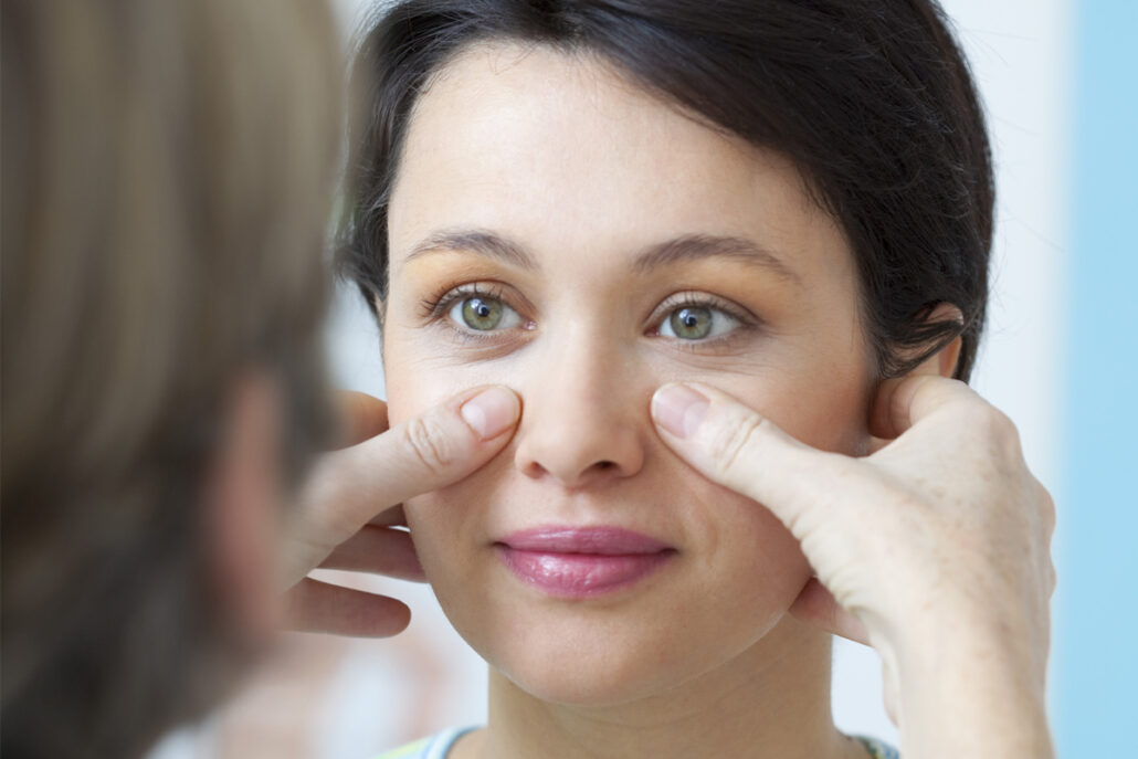 Eye specialist examining a patient for severe allergic conjunctivitis and possible surgical treatment options.