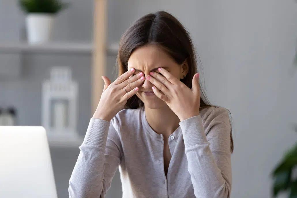 Female patient rubbing here eyes in relation to allergies and dry eyes.