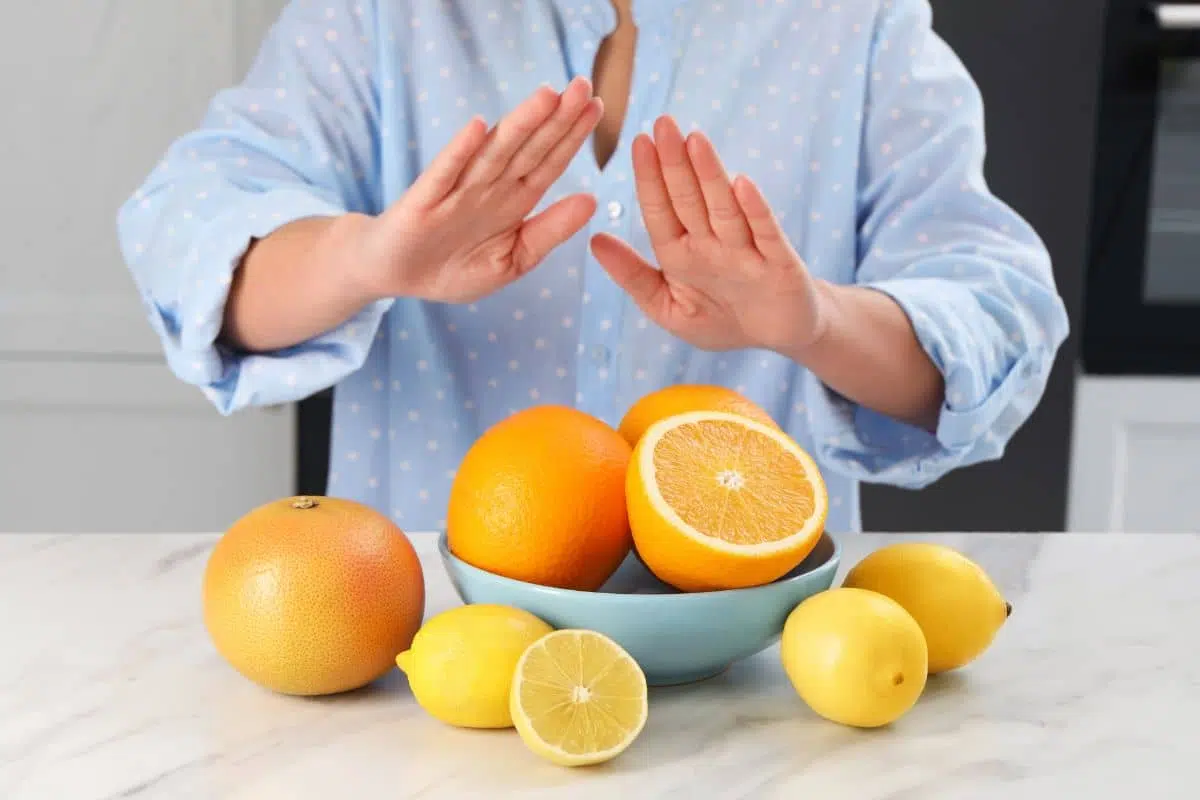 Person avoiding fruits due to oral allergy syndrome caused by pollen-related food sensitivities.