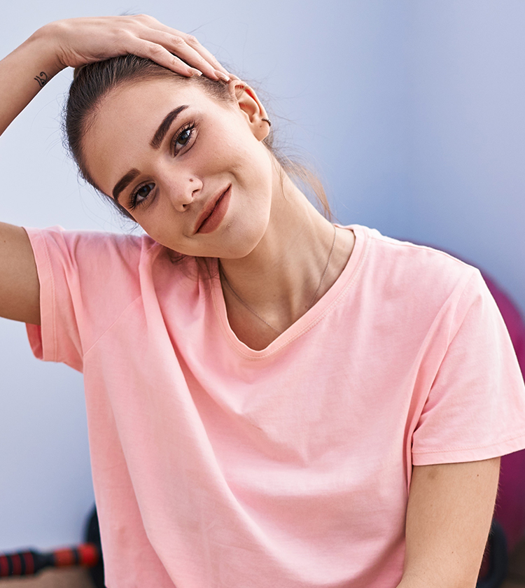 Young woman tilting head with hand, representing awareness of congenital neck cyst risks and potential complications