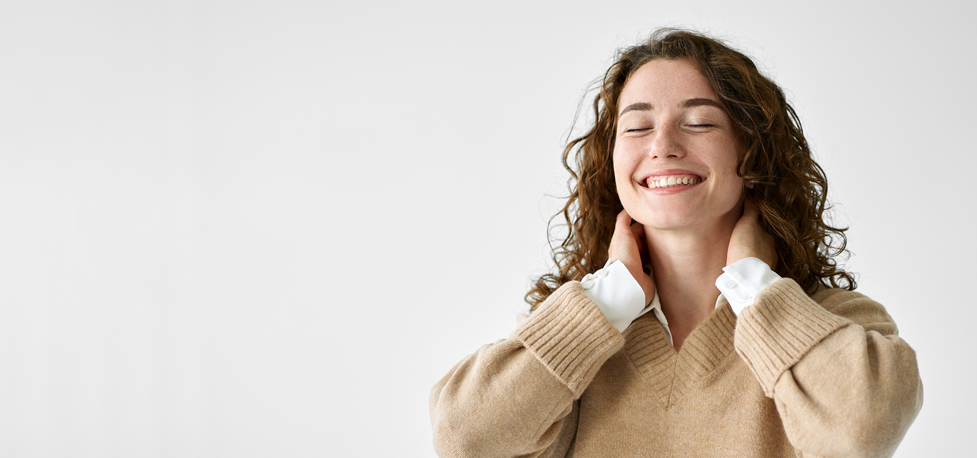 Smiling woman touching neck, symbolizing awareness of neck masses and the importance of early medical evaluation.