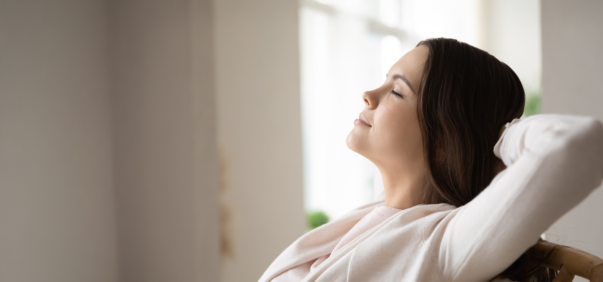 Woman relaxing with closed eyes and peaceful expression after receiving post-nasal drip treatment in Philadelphia