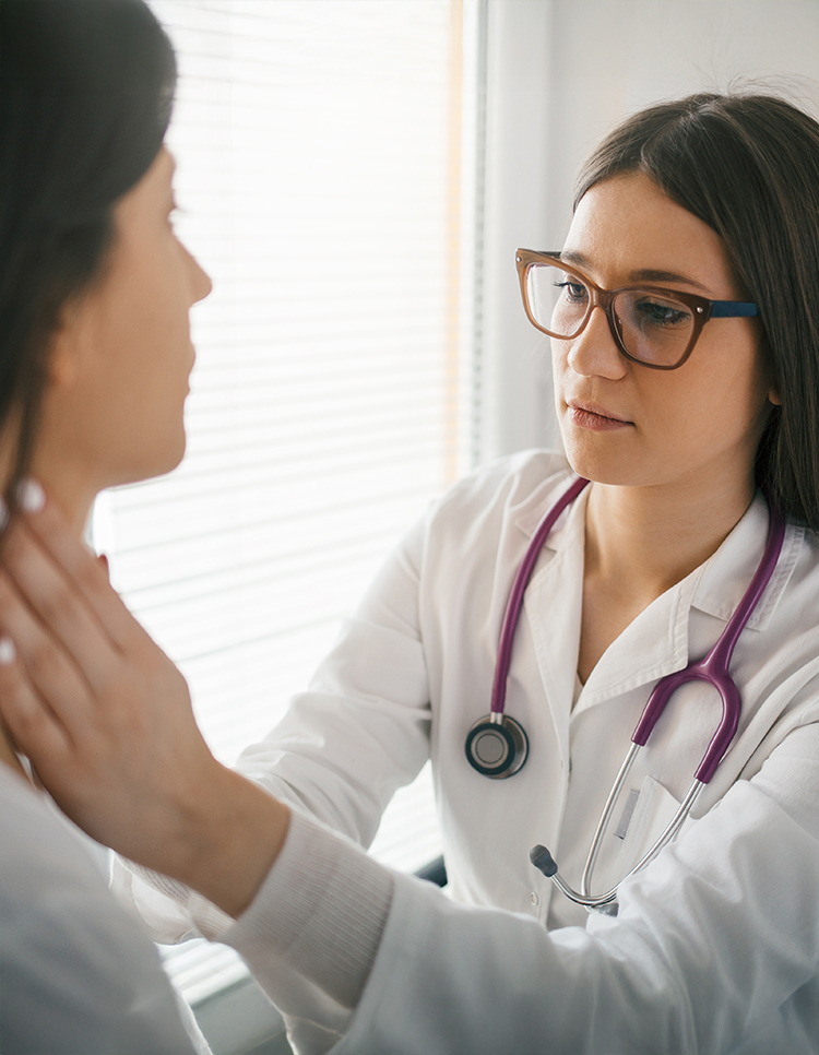Female doctor palpating patient’s neck to check for salivary gland swelling or masses during clinical exam