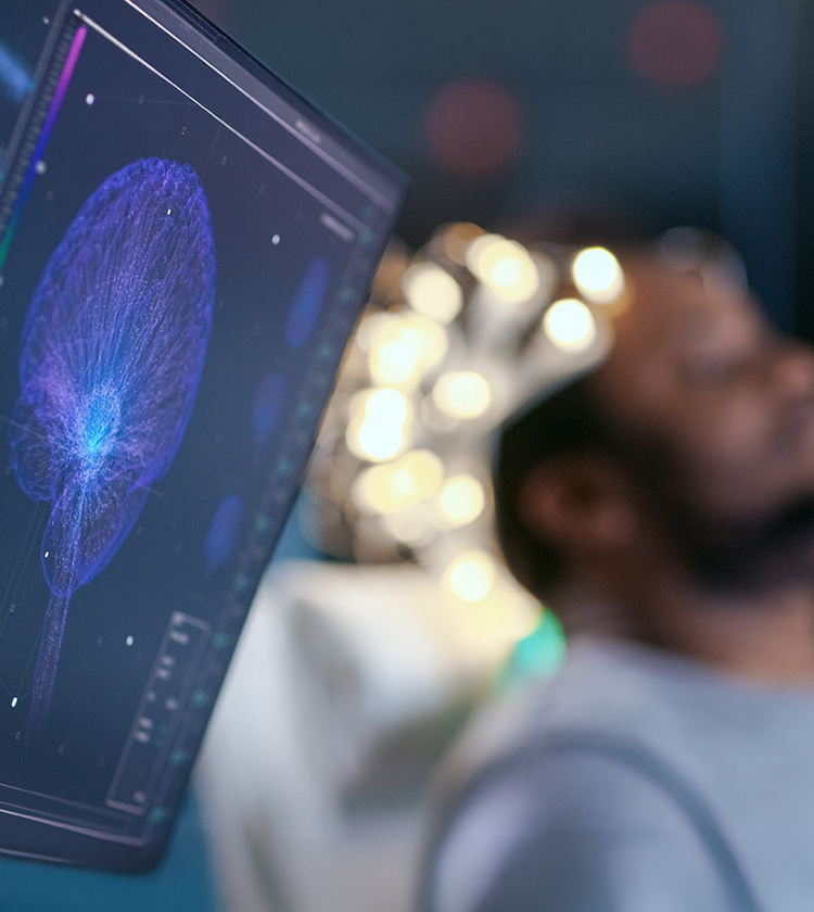 Patient undergoing sleep study with EEG cap while brain activity is monitored on screen for insomnia diagnosis