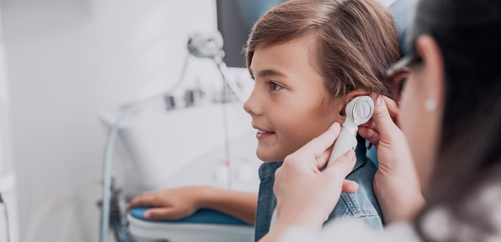 Doctor examining a child’s ear during allergy diagnosis and testing to identify triggers and guide treatment.