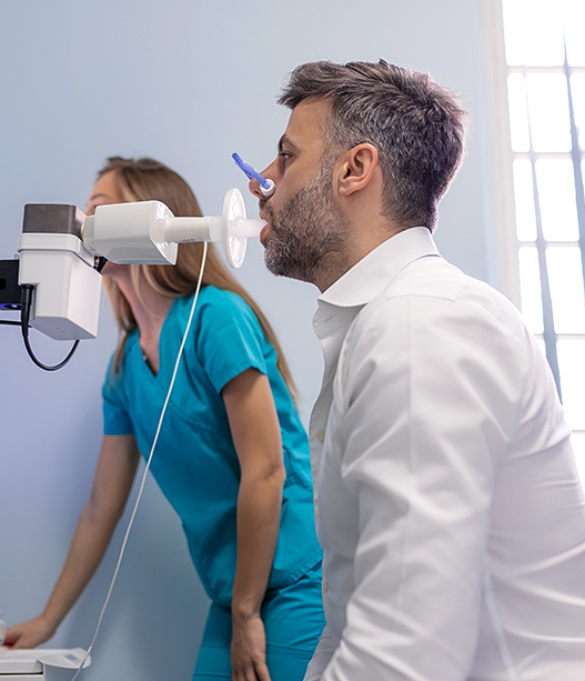 Patient undergoing breathing test with nasal device to evaluate airflow and diagnose sleep apnea in clinic