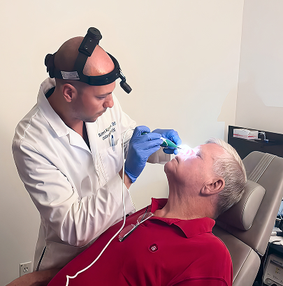 ENT doctor performing nasal endoscopy on patient using lighted scope in clinical examination room