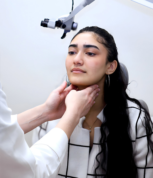 Doctor examining patient’s neck to assess thyroid gland and detect possible thyroid conditions in clinical setting