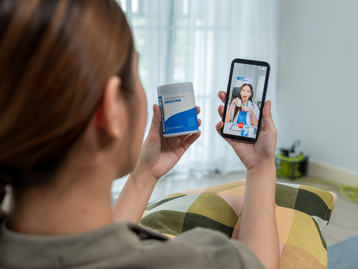 Patient attending an online allergy TeleVisit from home while reviewing medication with a doctor.