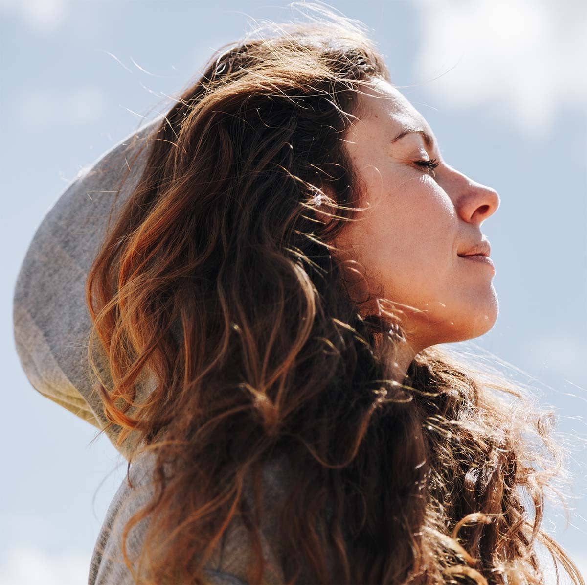 Woman breathing outdoors, representing middle turbinate surgery and additional procedures to improve nasal airflow and reduce congestion.