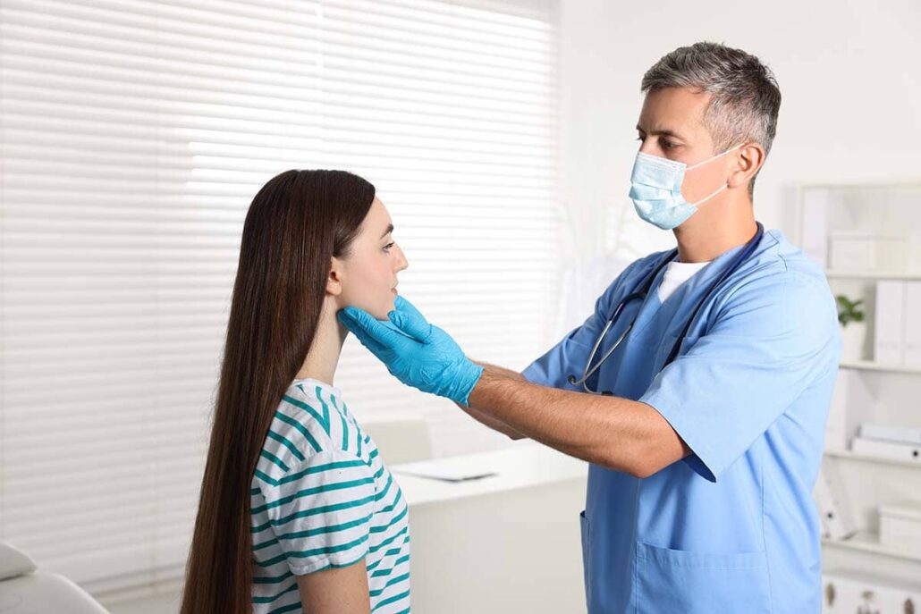 Medical team discussing salivary gland treatment options with a patient, including surgical and minimally invasive procedures.