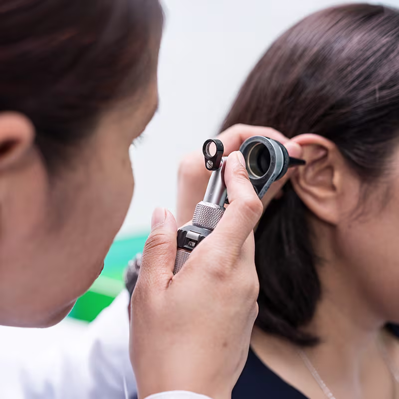 Audiologist examining a patient’s ear during a hearing loss consultation and comprehensive hearing evaluation.