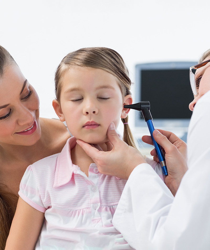 Pediatric ENT doctor examining a child’s ear during treatment evaluation for ear infections in children.