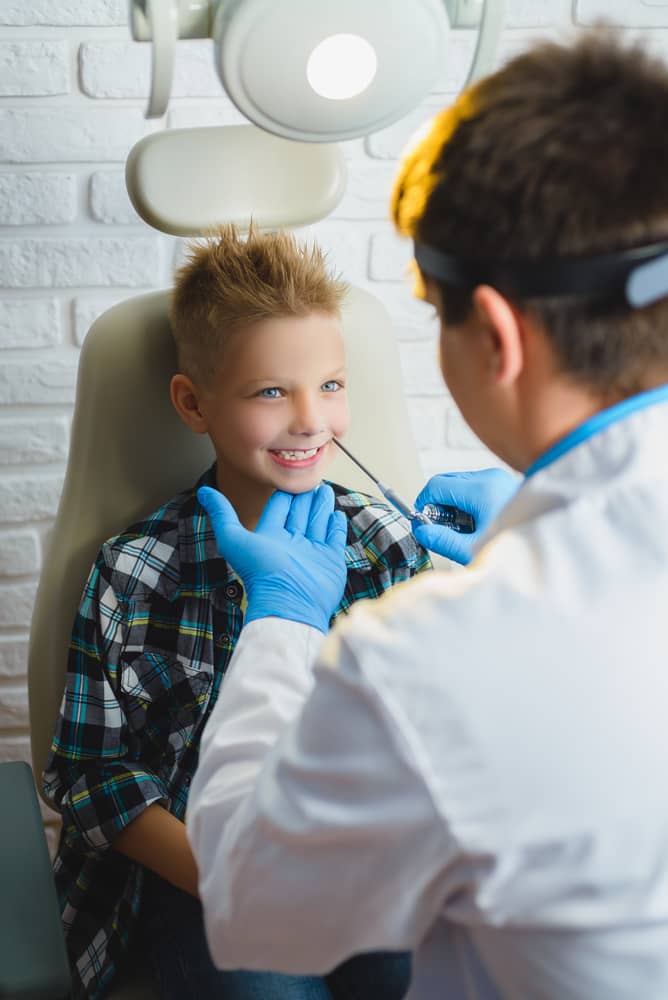 Pediatric ENT doctor examining a child during evaluation for sinus infections and allergy-related symptoms.