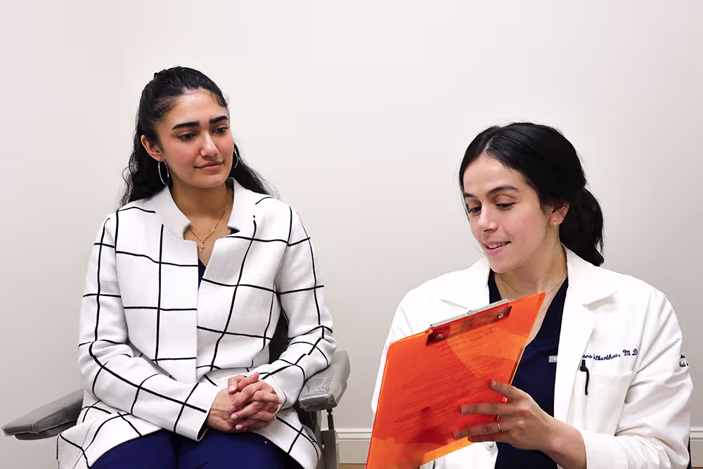 Patient meeting with ENT specialist during follow-up appointment to monitor and manage laryngopharyngeal reflux symptoms.
