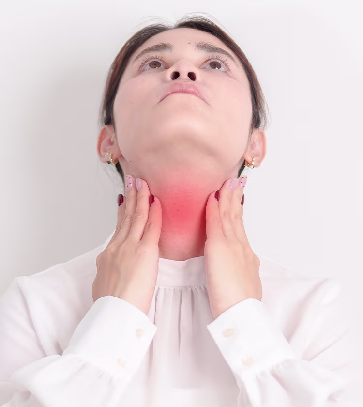 Woman touching neck illustrating thyroid disease symptoms and treatment options for hormone balance.